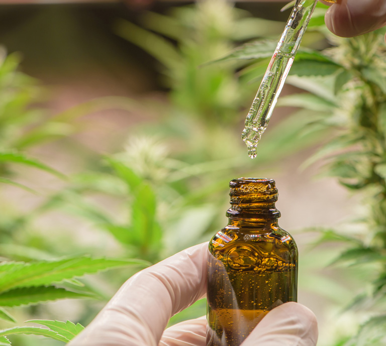 scientist-holding-a-bottle-of-cannabis-oil